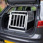 Single door aluminium car dog crate positioned inside a vehicle boot, showing size and fit for car travel