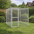 Outdoor dog run made from galvanised steel installed on lawn in garden setting with fence and trees