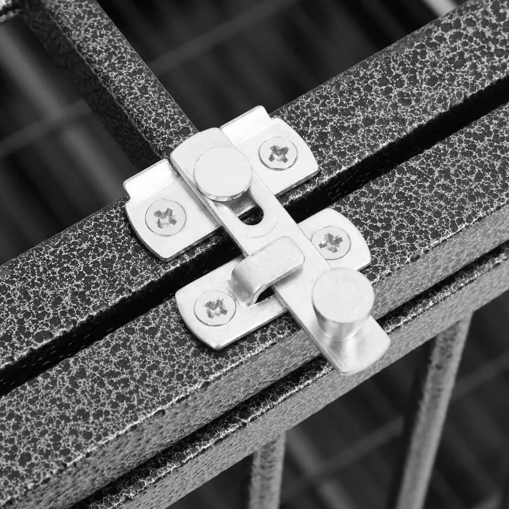 Close-up of dual metal safety latches on hinged door of steel dog crate