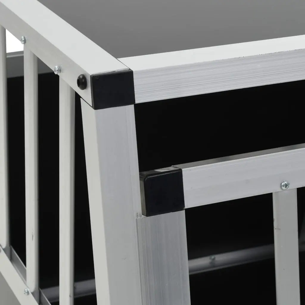 Close-up of aluminium frame and black plastic corner connectors on single door car dog crate