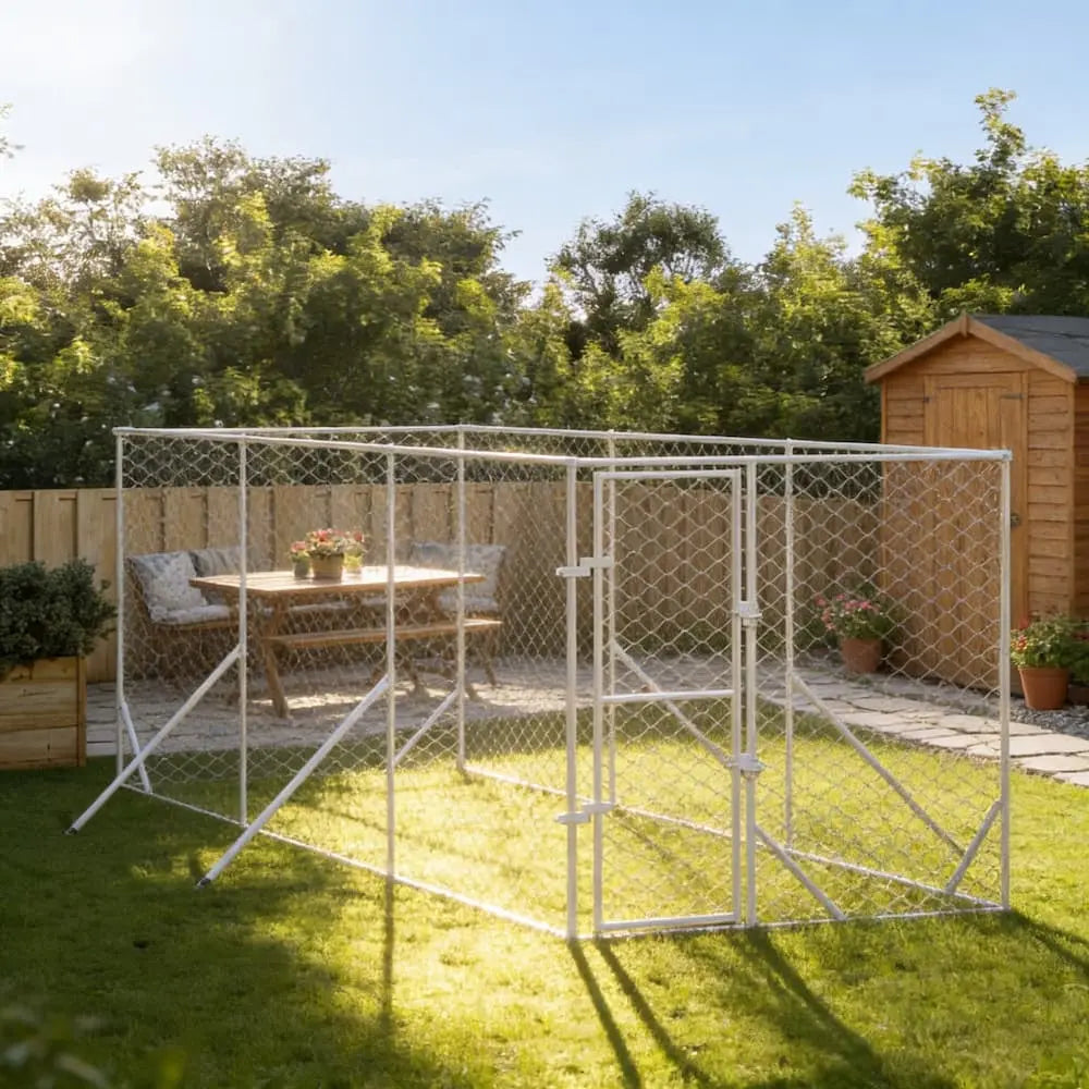 Large galvanised steel walk-in dog run on a green garden lawn with a wooden shed background
